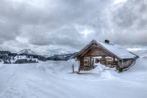 Winter House And Cloudy Skies Wallpaper