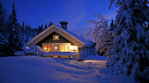 Winter House With A Lit Porch Wallpaper