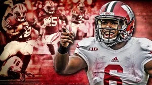 Wisconsin Badgers Football Team In Action At A Packed Stadium Wallpaper