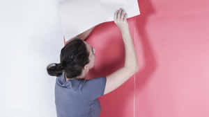 Woman Applying Posteron Wall Wallpaper