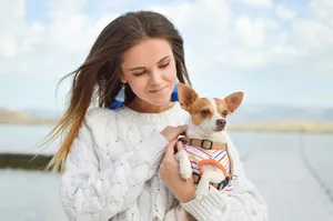 Woman Carrying Pet Dog Wallpaper