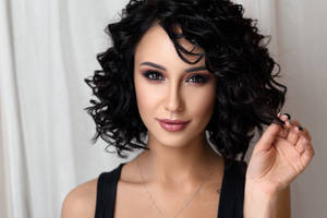 Woman Embracing Her Gorgeous Black Curls Wallpaper