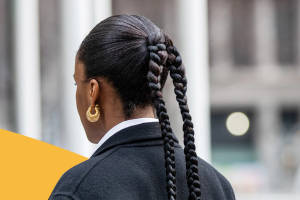 Woman Empowerment In Corporate Fashion - Boss Lady In A Suit With Stylish Braids Wallpaper