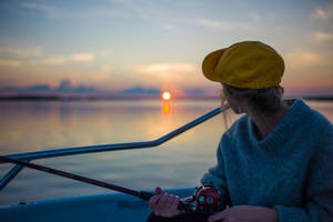 Woman Fishing At Finland Sunset Wallpaper
