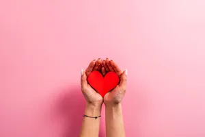 Woman Holding Aesthetic Heart Paper Cutout Wallpaper