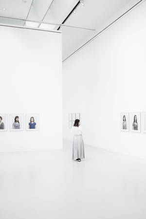 Woman Inside A Bright White Gallery Wallpaper