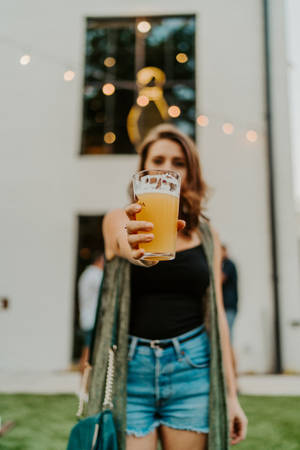Woman Raising Beer Wallpaper