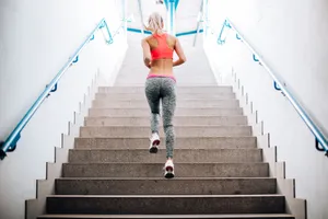 Woman Running Up Stairs Flex Calves Wallpaper