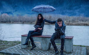 Woman Shielding Man With Umbrella Rainy Weather Wallpaper