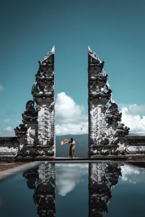 Woman Standing At Hindu Temple Wallpaper