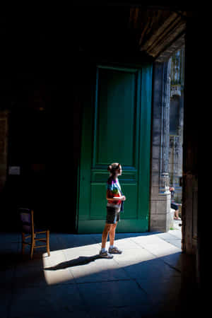 Woman Standing By Open Door Wallpaper