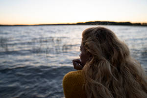 Woman Staring At Lake Finland Wallpaper