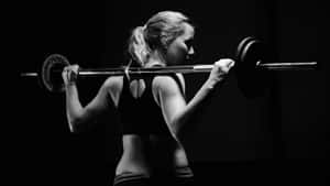 Woman Weightlifting Session Wallpaper