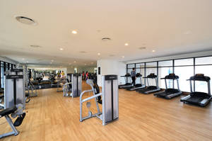 Wood-paneled Gym With Treadmills Wallpaper