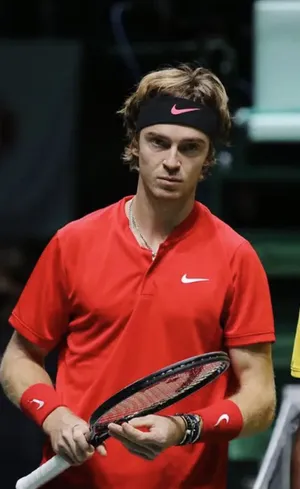 World-renowned Tennis Player, Andrey Rublev Holding A Tennis Racket Wallpaper