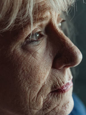 Wrinkled Woman Sad Eyes Wallpaper