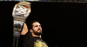 Wwe Wrestler Seth Rollins Raising His Belt Wallpaper