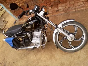 Yamaha Rx100 Near A Brick Wall Wallpaper