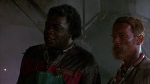 Yaphet Kotto And Arnold Schwarzenegger In The Running Man Wallpaper