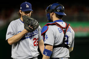 Yasmani Grandal Talking With Pitcher Wallpaper