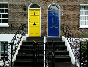 Yellow And Blue Wood Doors In Brick Walls Wallpaper