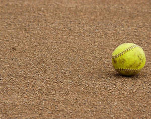 Yellow Cute Softball On The Ground Wallpaper