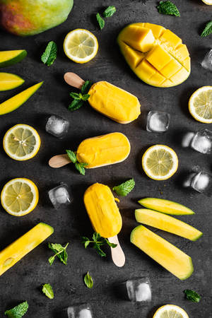 Yellow Popsicles With Mint And Citrus Fruits Wallpaper