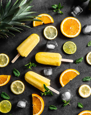 Yellow Popsicles With Mint And Yellow Fruits Wallpaper