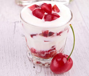 Yogurt Delight With Cherry Topping Wallpaper