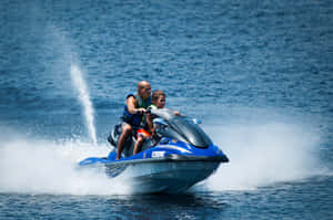 Young Boy Enjoying A Jet Ski Ride Wallpaper