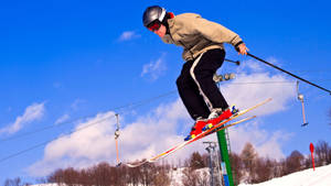 Young Man Ski Jumping Position Wallpaper