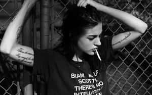 Young Woman Enjoying A Cigarette Break Wallpaper