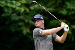 Zach Johnson Swinging A Black Club Wallpaper