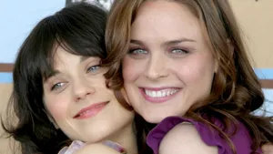Zooey Deschanel And Emily Deschanel Hugging Wallpaper