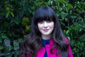 Zooey Deschanel Pink And Blue Outfit With Plants Wallpaper